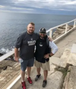 Coach Michael Baggetta (right) stands with Australian host and tour guide Adam "Squizzy" Taylor.