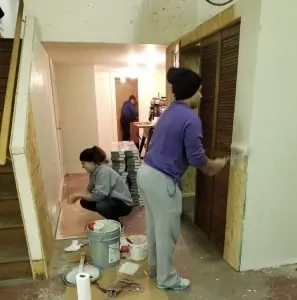Ferrum College students and staff worked with Habitat for Humanity to renovate a local woman's home. Pictured: staff member Leya Deickman '19 (in purple), student Katrina Anderson (in grey), and Morgan Flinkstrom (in blue).