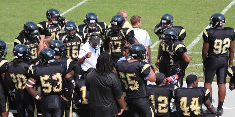 Coach Adams having an in-game discussion with Ferrum Football players.