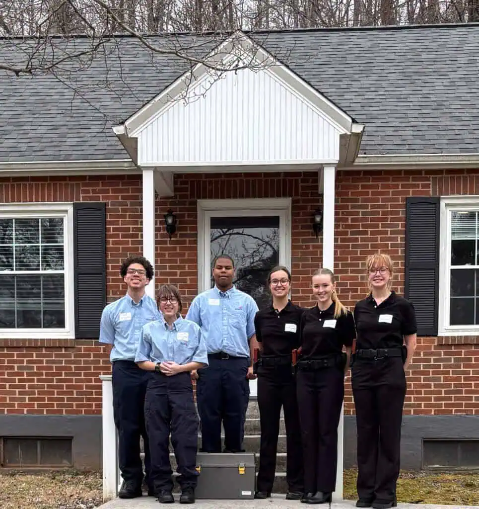 Students from E.C Glass and Franklin County stand in front of the Ferrum College Crime House
