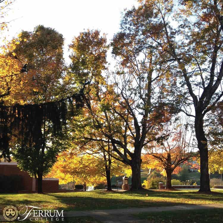 fall photo of main campus with parts of brick buildings including Garber Hall and colored leaves on bushes and trees