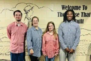 Four new Jack Tale Players in red and blue gingham shirts in front of Jack Tale wall