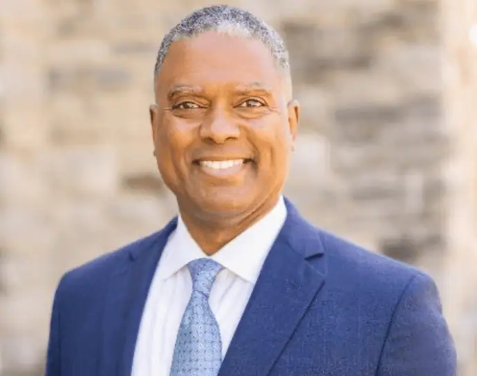 Headshot of Gerard Robinson in a navy suit and light blue tie