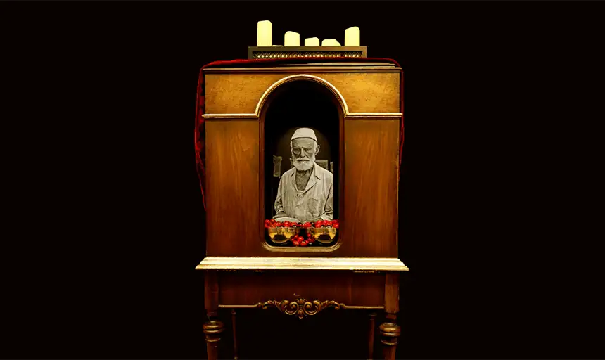 Image of artwork featuring faux cherries, LED candles, monitor, repurposed cabinet, metal bowls, cloth, wood