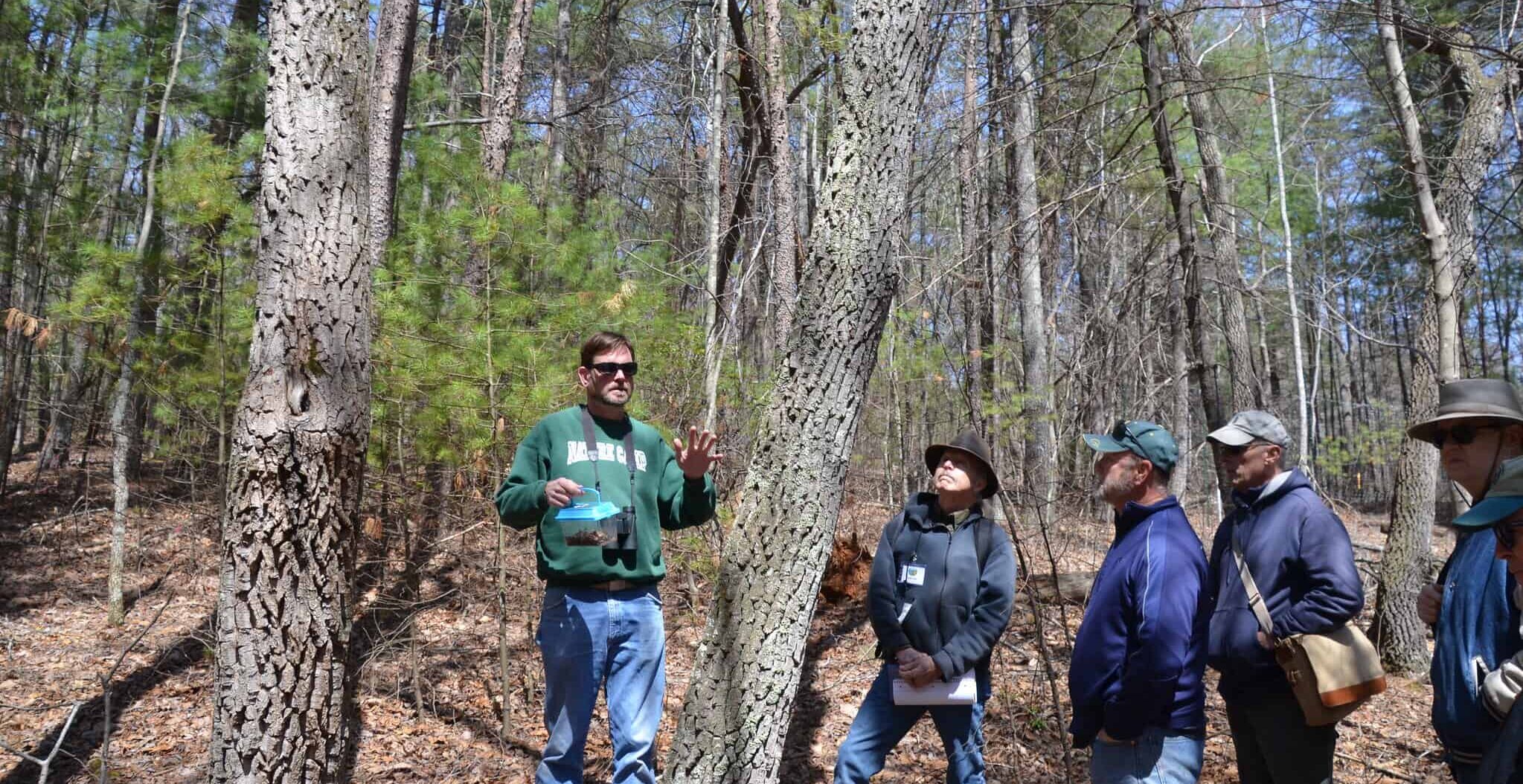 Todd Fredericksen with master naturalists in the woods in 2018