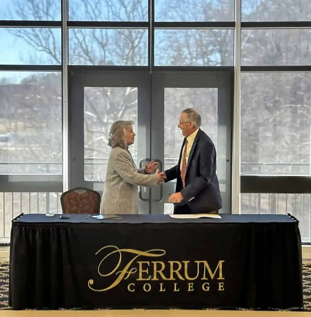 Ferrum College President Mirta Martin and NCLab President Leonard Lafrance shake hands after signing an agreement to offer Industry-Recognized Credentials