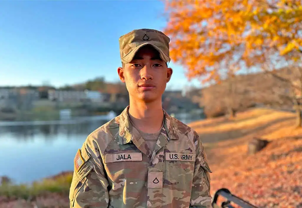 Ferrum College student Tripoom Jala standing at Adams Lake on campus