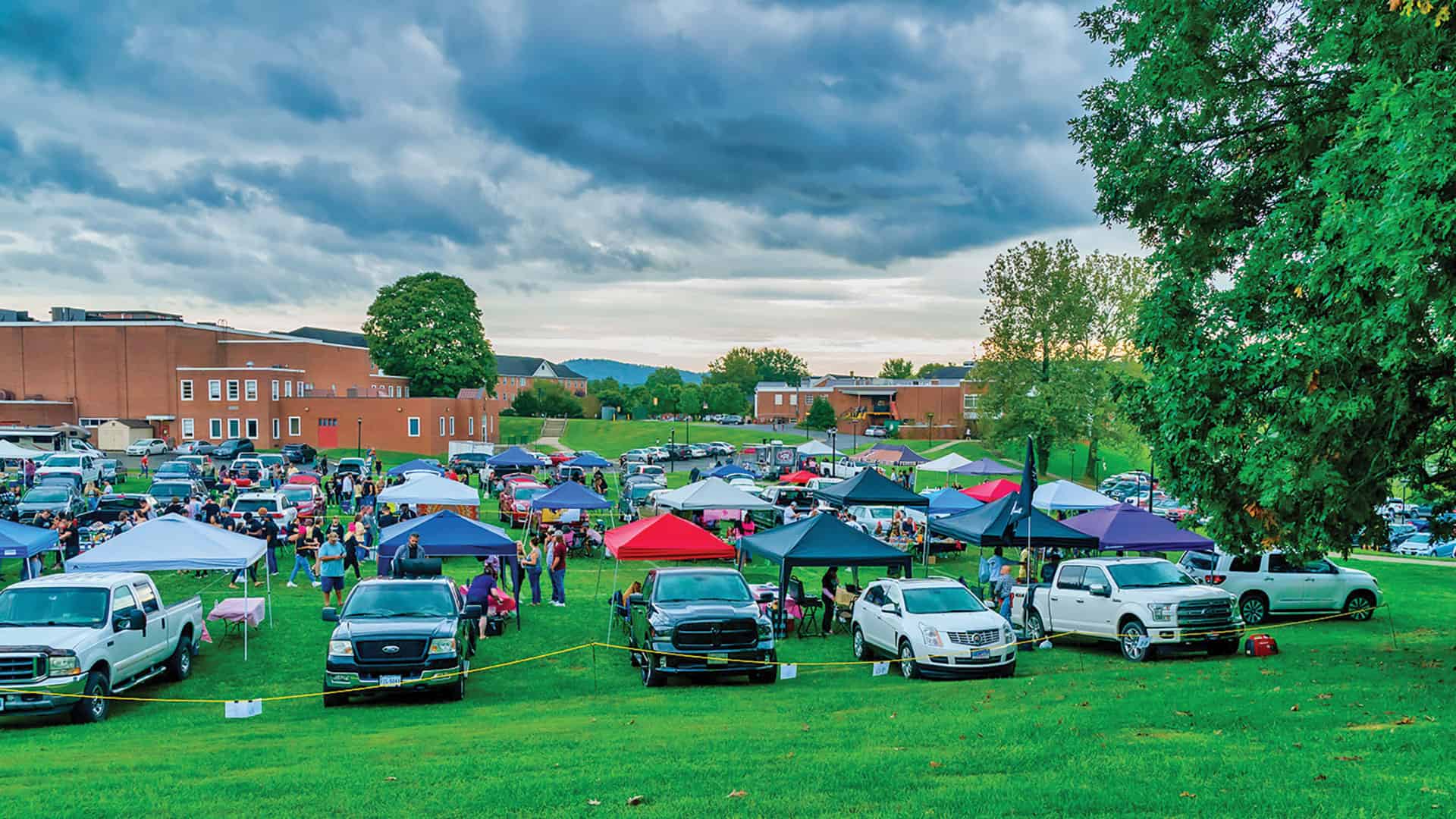 Basset Field at Ferrum College is filled with vehicles, people, and tents