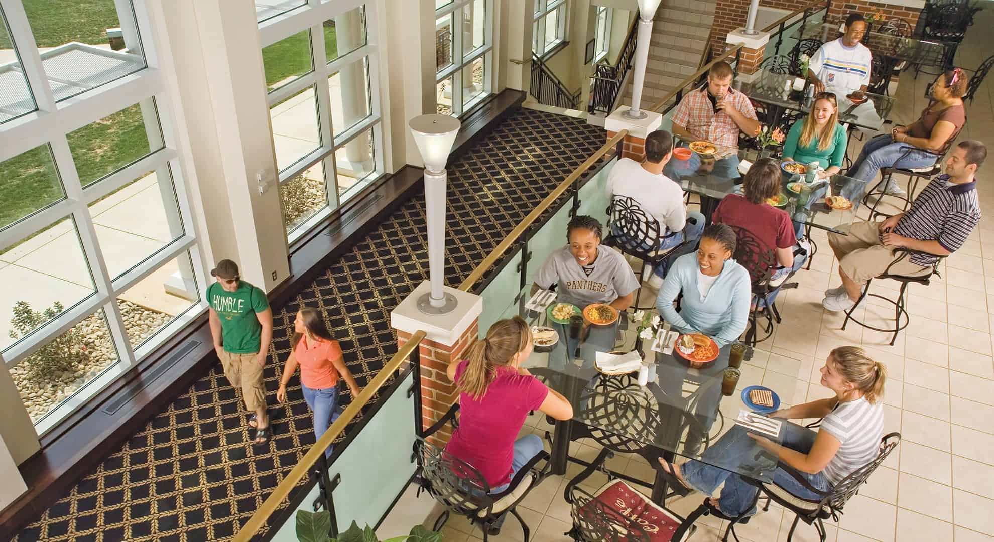 Ferrum College students sitting at tables with food in Franklin dining hall.